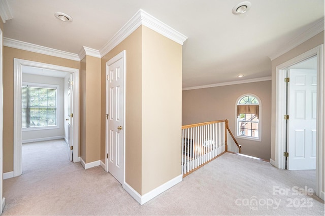 hall with carpet floors, crown molding, baseboards, recessed lighting, and an upstairs landing