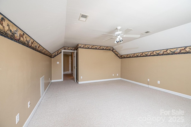 bonus room featuring visible vents, lofted ceiling, baseboards, light colored carpet, and a ceiling fan