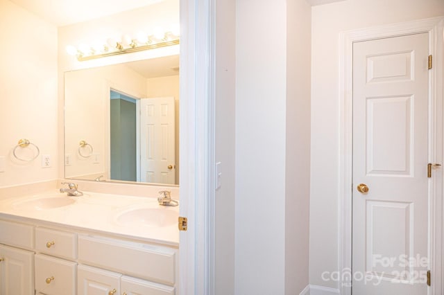 bathroom with a sink and double vanity