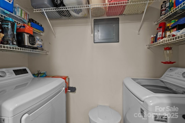 washroom featuring electric panel, laundry area, and washing machine and clothes dryer