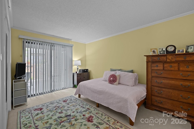 bedroom with carpet floors, ornamental molding, and a textured ceiling