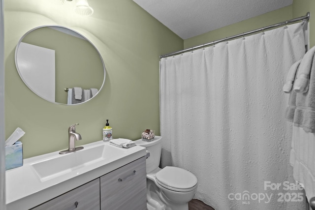 bathroom featuring vanity, a textured ceiling, curtained shower, and toilet