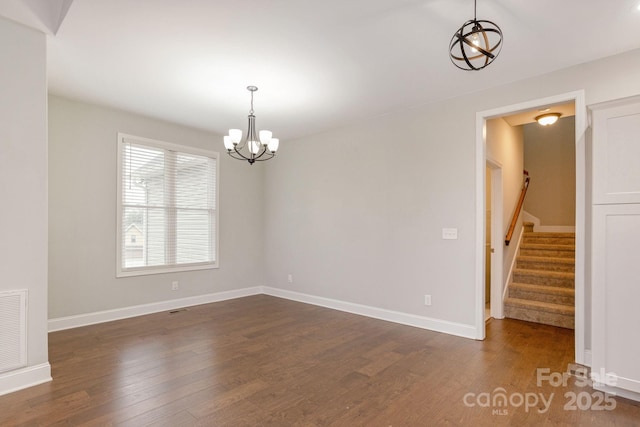 76 Tryon View Dr, Flat Rock, NC 28731 - spare room featuring an inviting chandelier, baseboards, stairs, and dark wood-style floors
