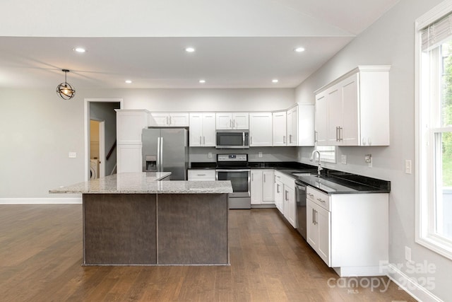76 Tryon View Dr, Flat Rock, NC 28731 - kitchen featuring appliances with stainless steel finishes, dark wood-style floors, a sink, and a center island
