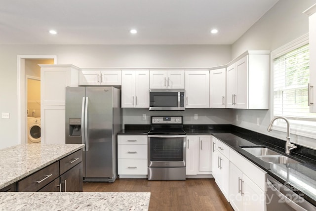 76 Tryon View Dr, Flat Rock, NC 28731 - kitchen with a sink, washer / dryer, appliances with stainless steel finishes, and white cabinets