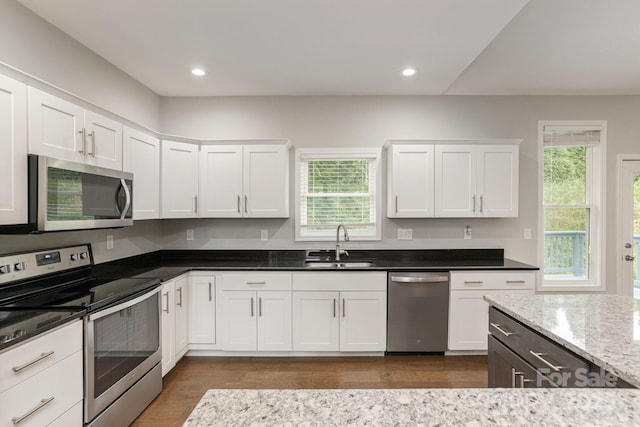 76 Tryon View Dr, Flat Rock, NC 28731 - kitchen with white cabinets, stainless steel appliances, a wealth of natural light, and a sink