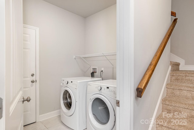 76 Tryon View Dr, Flat Rock, NC 28731 - laundry room featuring washing machine and clothes dryer, light tile patterned floors, laundry area, and baseboards