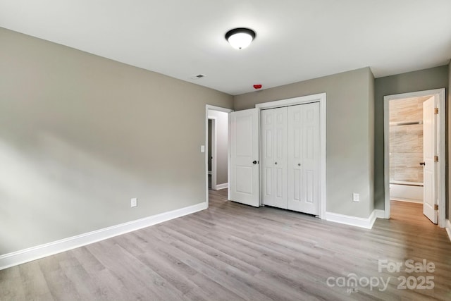 131 Little Forest Ln, Statesville, NC 28625 - unfurnished bedroom with baseboards, a closet, wood finished floors, and visible vents