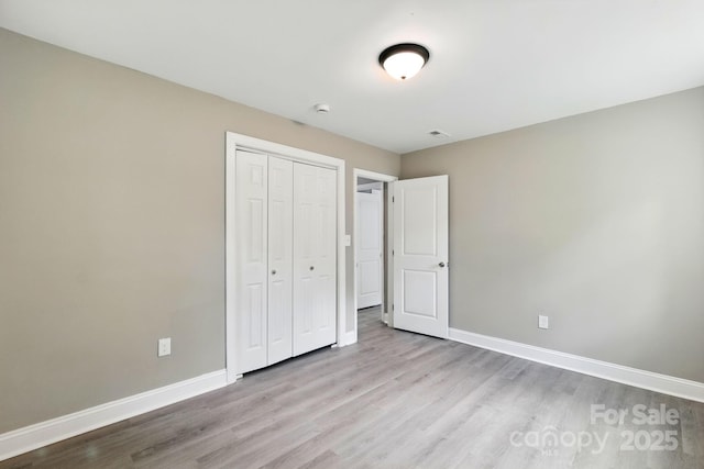 131 Little Forest Ln, Statesville, NC 28625 - unfurnished bedroom with baseboards, a closet, and wood finished floors