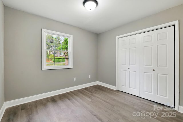 131 Little Forest Ln, Statesville, NC 28625 - unfurnished bedroom with baseboards, wood finished floors, and a closet