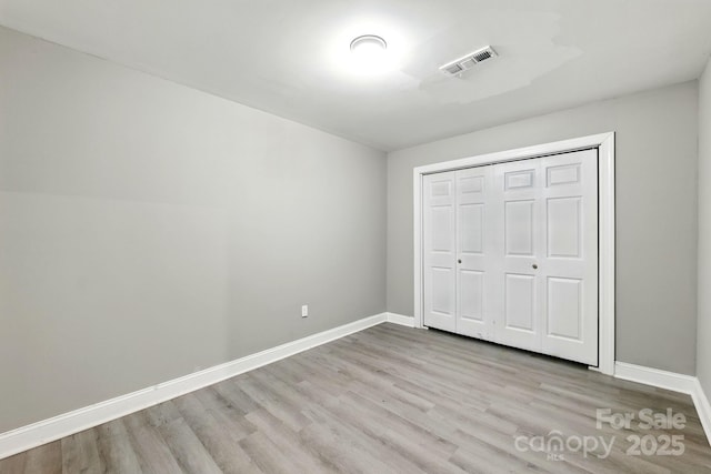 131 Little Forest Ln, Statesville, NC 28625 - unfurnished bedroom with baseboards, wood finished floors, visible vents, and a closet
