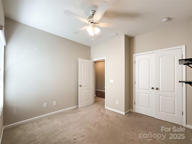 unfurnished bedroom featuring a closet, baseboards, carpet flooring, and visible vents