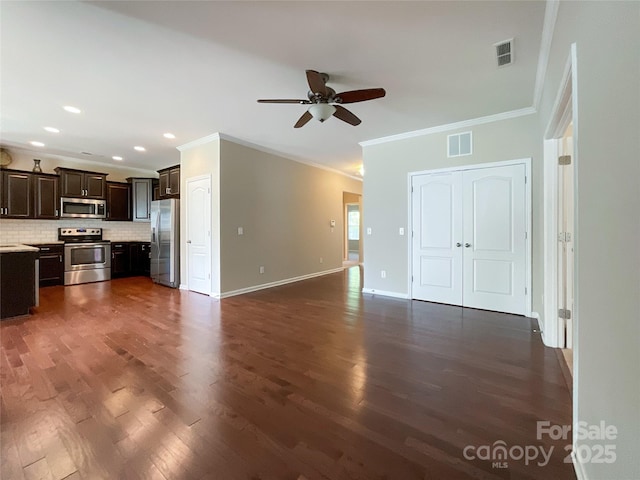 unfurnished living room featuring a ceiling fan, visible vents, crown molding, baseboards, and dark wood-style floors