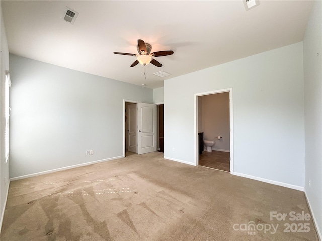 unfurnished bedroom featuring carpet floors, baseboards, visible vents, and connected bathroom