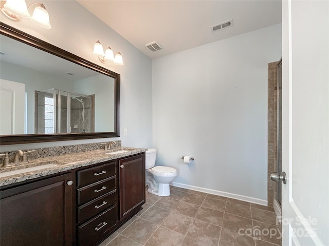 bathroom with a sink, a shower stall, and visible vents