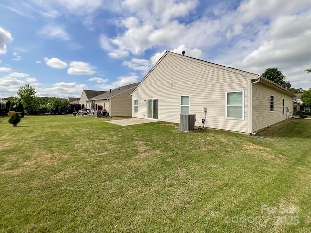 rear view of house featuring a yard, a patio area, and central air condition unit