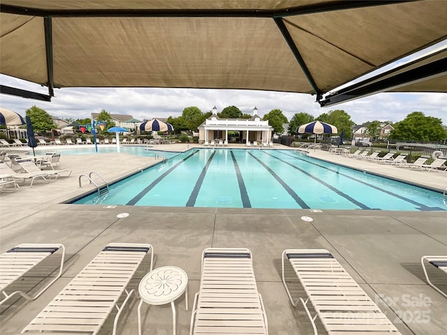 community pool featuring a patio and fence