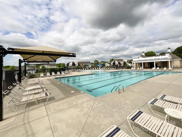 pool featuring a patio area and fence