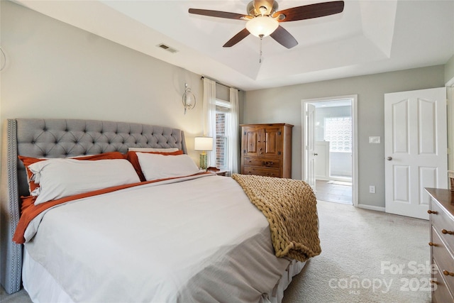 7700 Ninth Fairway Ln, Mint Hill, NC 28227 - bedroom with light carpet, a raised ceiling, ensuite bath, a ceiling fan, and visible vents