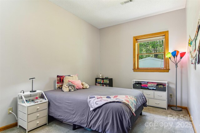 bedroom featuring light colored carpet, baseboards, and visible vents