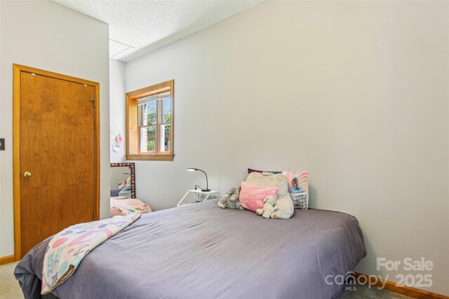 carpeted bedroom with baseboards