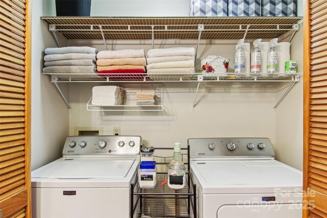 clothes washing area with separate washer and dryer and laundry area