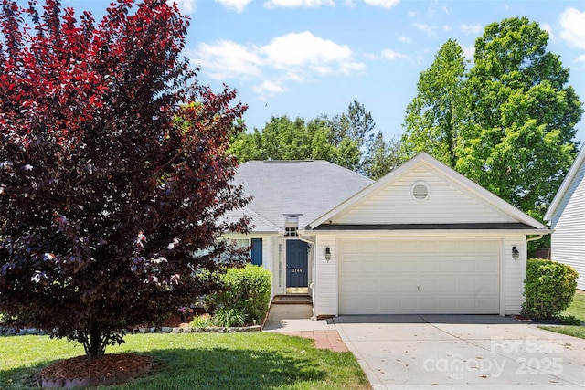 view of front of property featuring a garage, concrete driveway, and a front yard