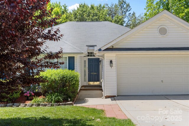view of front of house featuring driveway and a garage