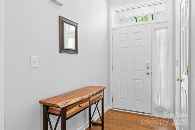 foyer with baseboards and light wood finished floors