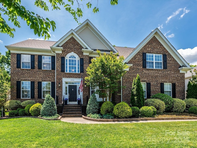 10944 Persimmon Creek Dr, Mint Hill, NC 28227 - view of front facade featuring a front yard and brick siding