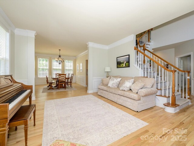 10944 Persimmon Creek Dr, Mint Hill, NC 28227 - living area featuring crown molding, a chandelier, stairway, and light wood-style floors