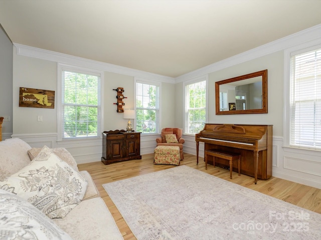 10944 Persimmon Creek Dr, Mint Hill, NC 28227 - sitting room featuring light wood-style floors, ornamental molding, and a wainscoted wall