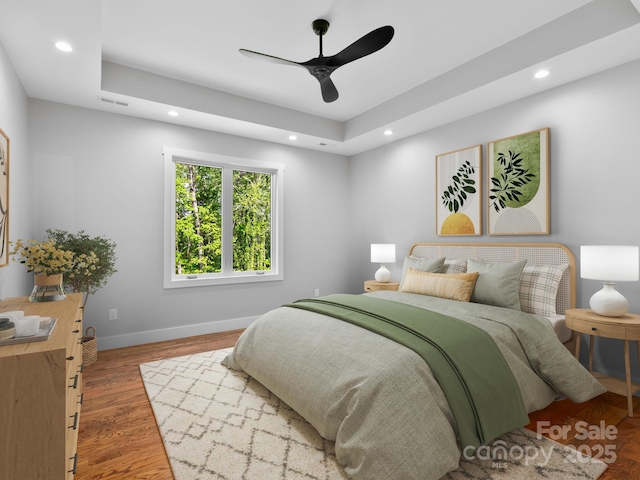 bedroom featuring a ceiling fan, recessed lighting, baseboards, visible vents, and a raised ceiling