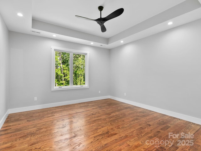 empty room with ceiling fan, wood finished floors, visible vents, and recessed lighting