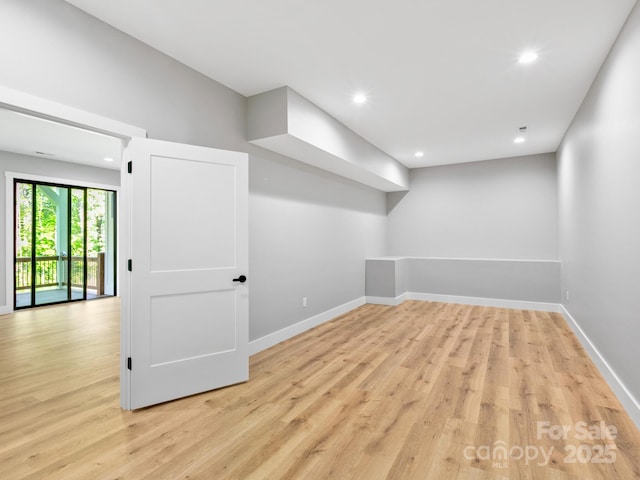 below grade area featuring baseboards, recessed lighting, and light wood-type flooring