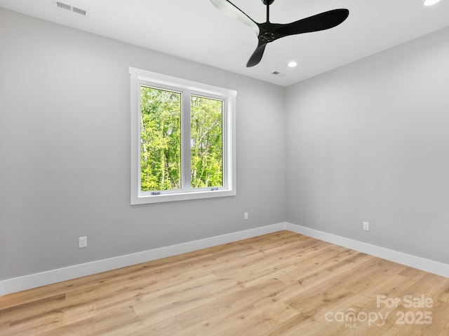 unfurnished room with baseboards, a ceiling fan, and visible vents