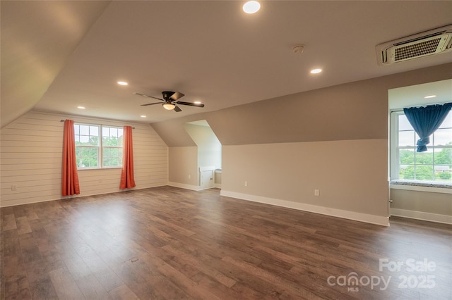 additional living space with dark wood-style flooring, a ceiling fan, lofted ceiling, baseboards, and recessed lighting