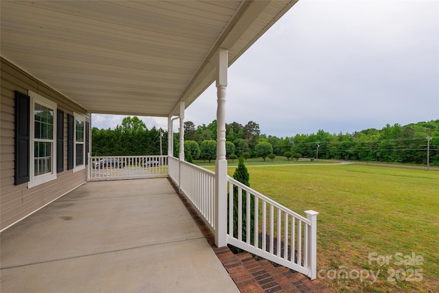 view of patio / terrace featuring covered porch and view of scattered trees