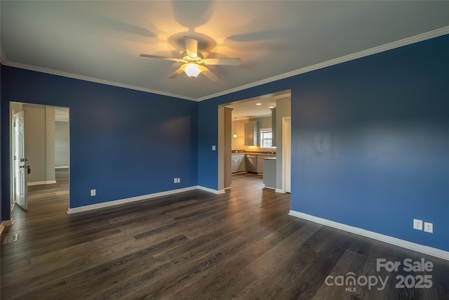 spare room featuring a ceiling fan, baseboards, dark wood-type flooring, and ornamental molding