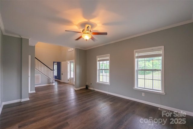 spare room with dark wood-type flooring, baseboards, stairs, a ceiling fan, and ornamental molding