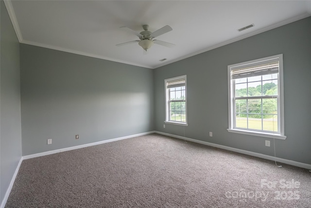 unfurnished room with crown molding, baseboards, carpet floors, and a ceiling fan