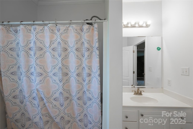 full bath featuring vanity, ornamental molding, and a shower with curtain