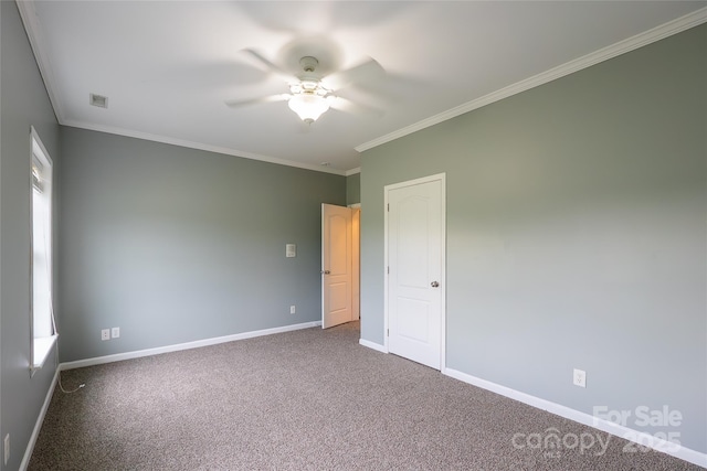 unfurnished bedroom with baseboards, ornamental molding, carpet flooring, and ceiling fan