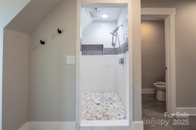 full bath featuring a shower stall, a bidet, and baseboards