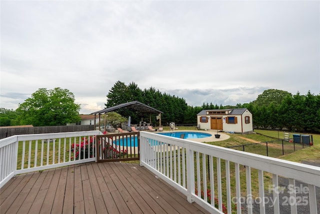 wooden deck featuring a gazebo, an outbuilding, and a shed