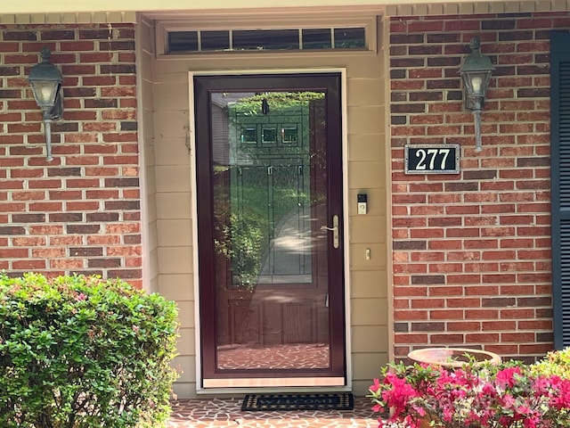 entrance to property with brick siding