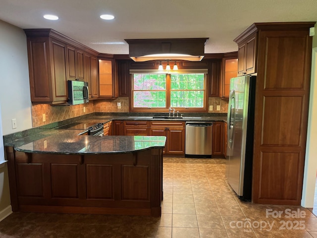 kitchen with a peninsula, recessed lighting, backsplash, light tile patterned floors, and stainless steel appliances