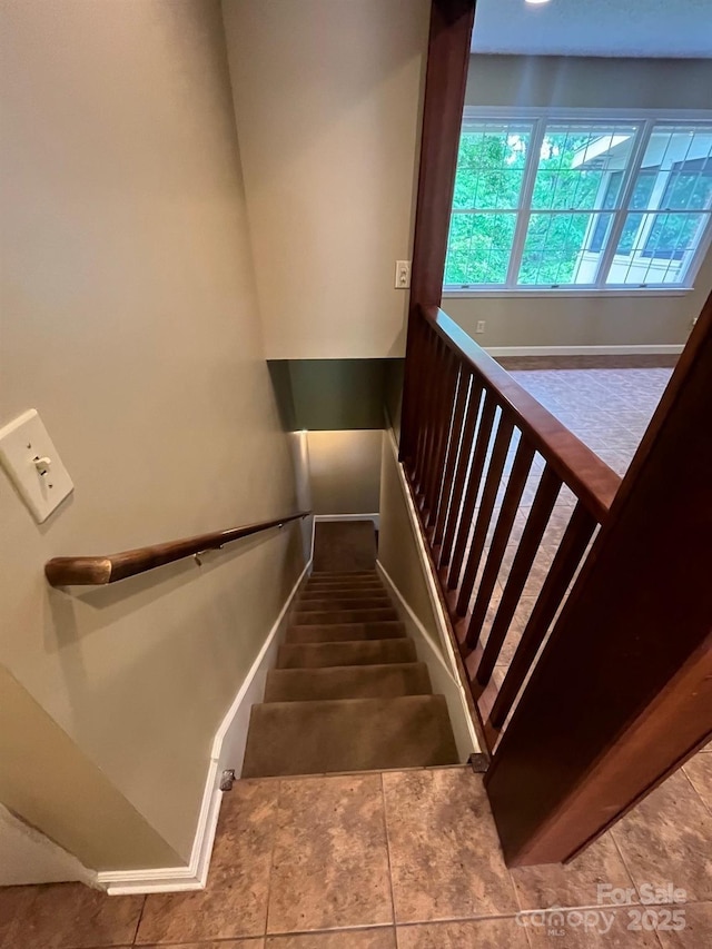 staircase featuring baseboards