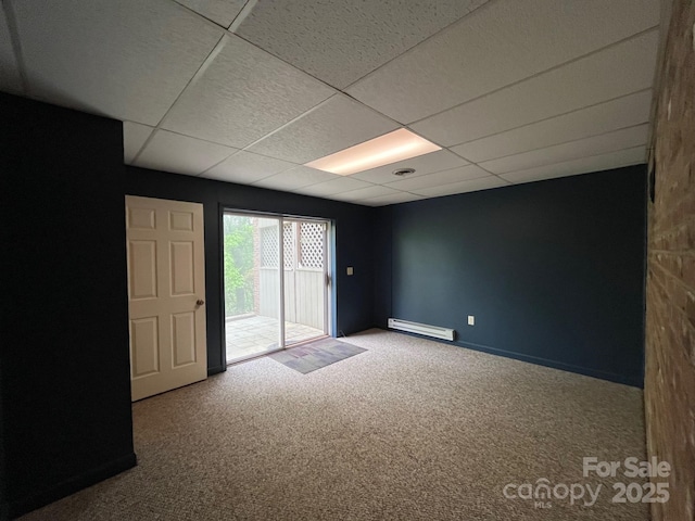 unfurnished room with carpet flooring, baseboards, a paneled ceiling, and baseboard heating