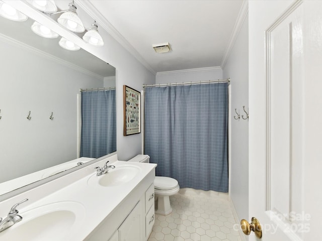bathroom with a sink, ornamental molding, and double vanity